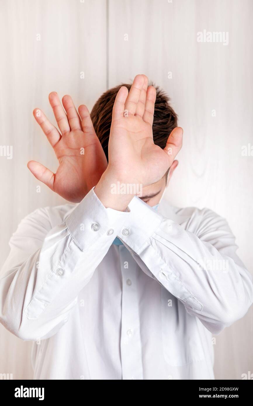 Man show refusal gesture with a Hands by the Wall in the Room Stock Photo