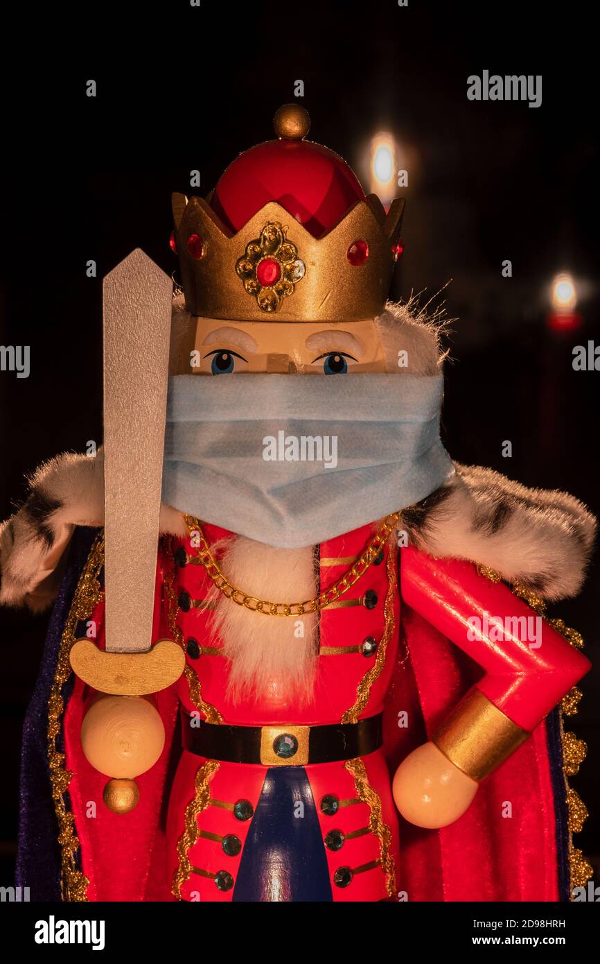 Traditional Christmas nutcracker wearing corona face mask Stock Photo