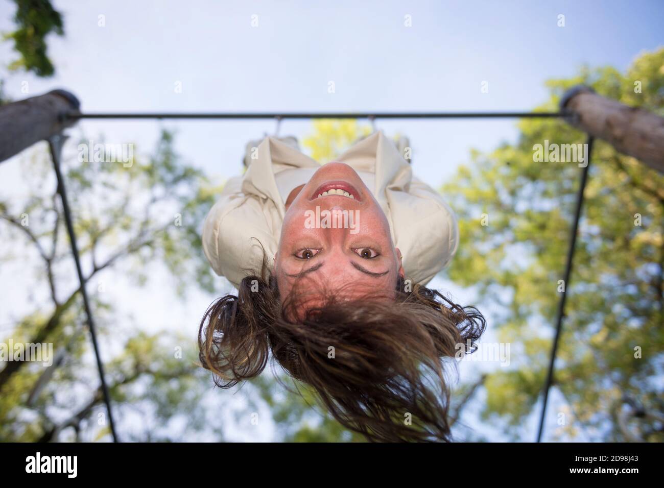 Woman Hanging Upside Down in Ticino, Switzerland. Stock Photo