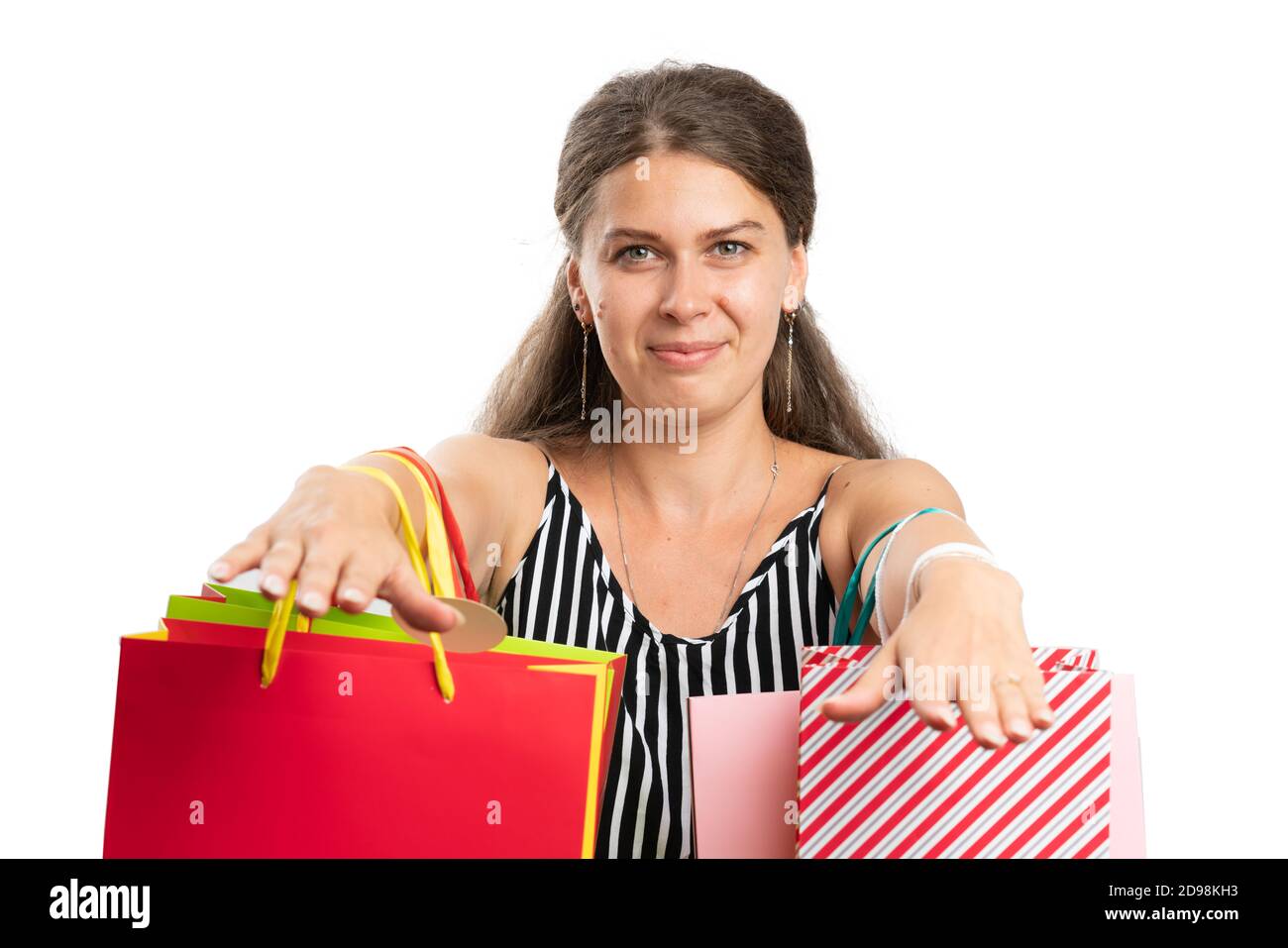 Shopaholic adult woman model showing bags full of colourful bags wearing modern fashionable casual summer attire as shopping concept close-up isolated Stock Photo