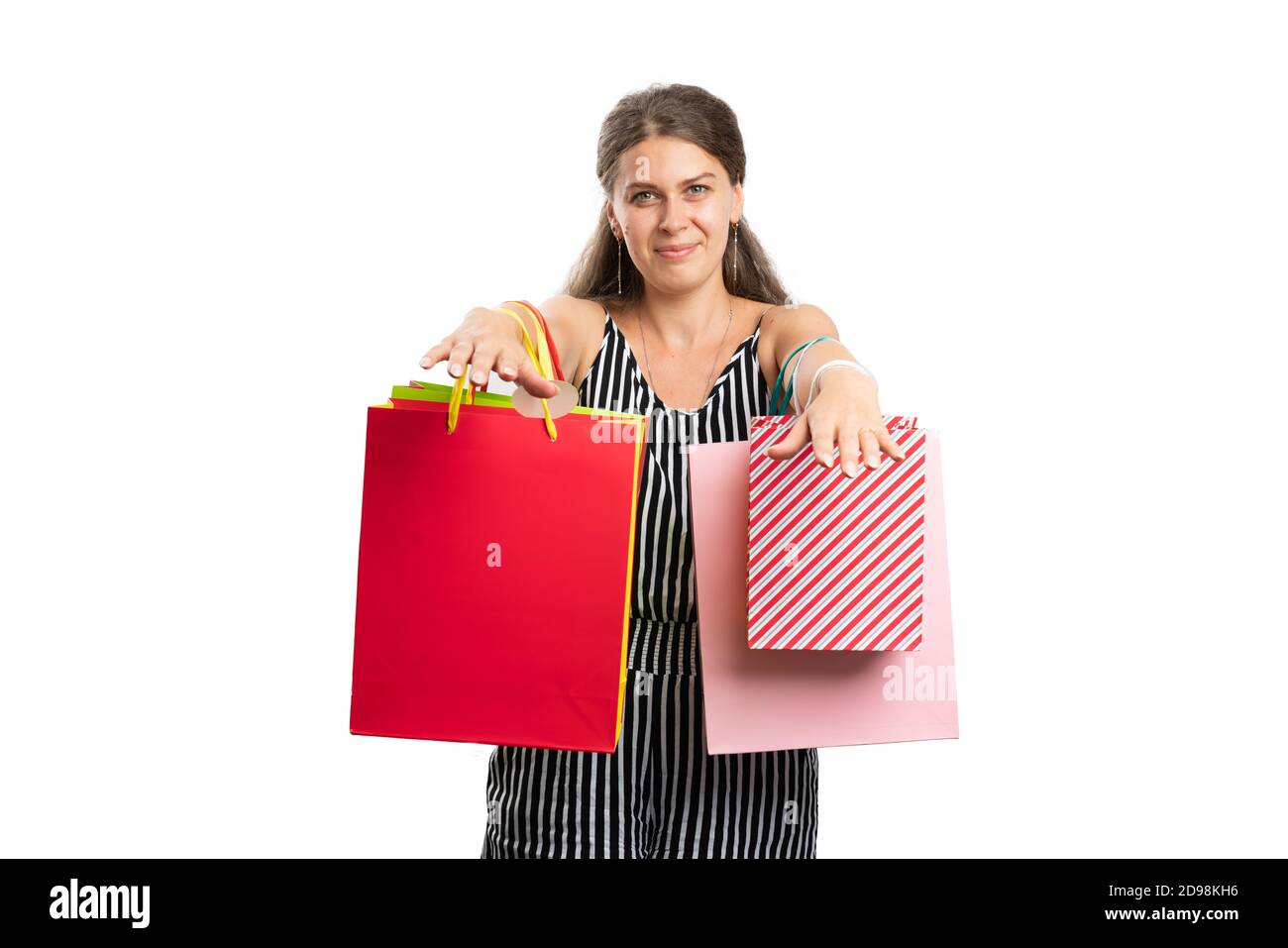 Adult woman model presenting shopping bags on hands wearing stylish summer clothing outfit as shopaholic consumerism lifestyle concept isolated on whi Stock Photo