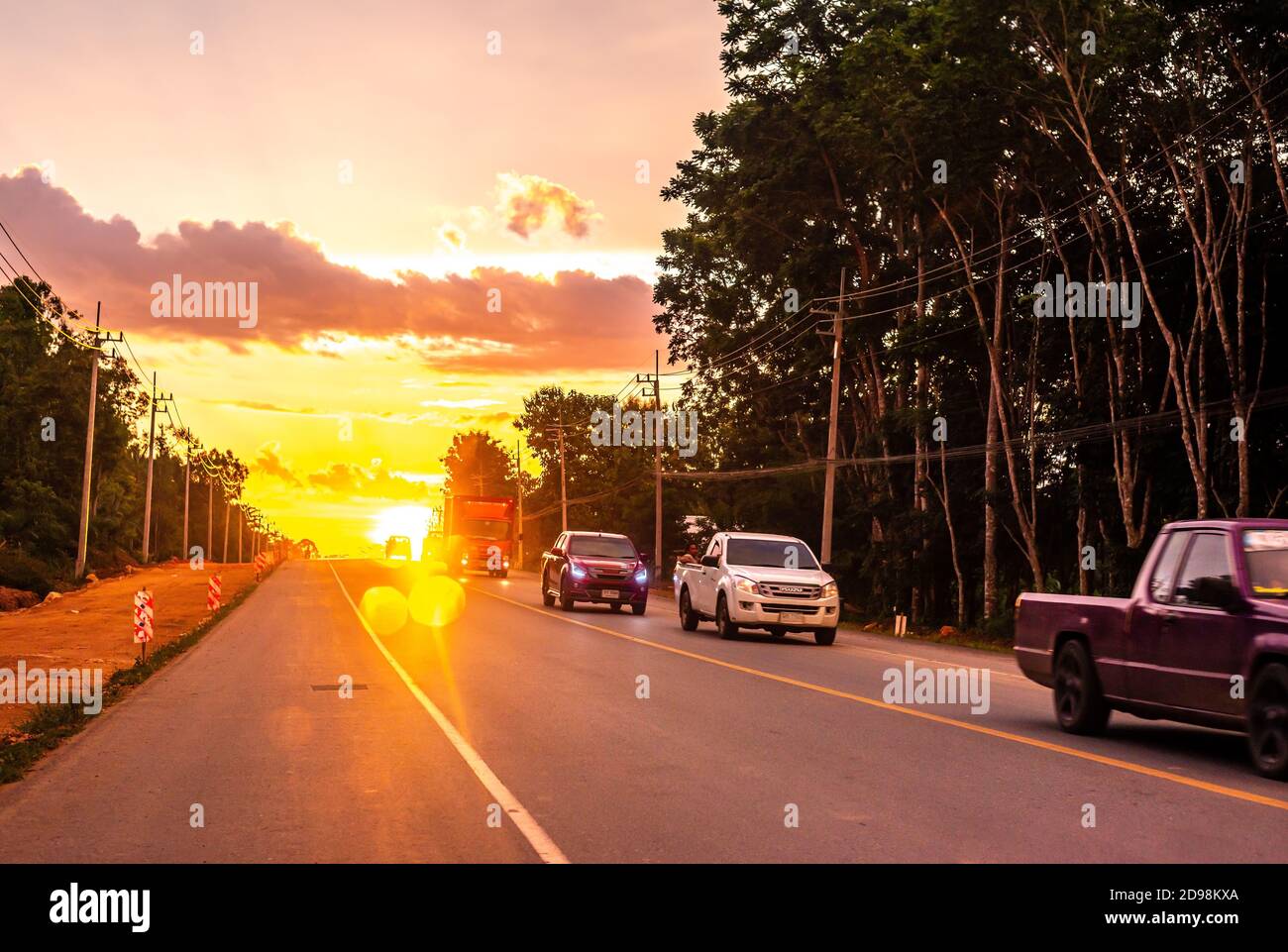 Pattalung, Thailand - August 29, 2020 : Car on road with colorful of sunset or sunrise in twilight Stock Photo