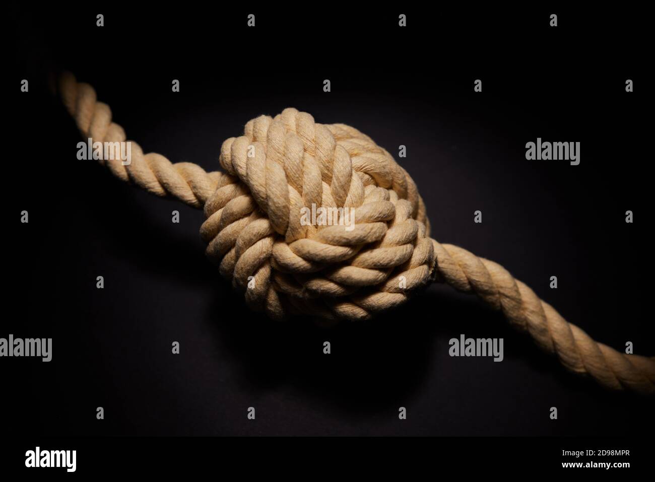 Concept Shot Of Rope Tied With Knot On Black Background To Illustrate Problem Or Mental Health Issue Stock Photo