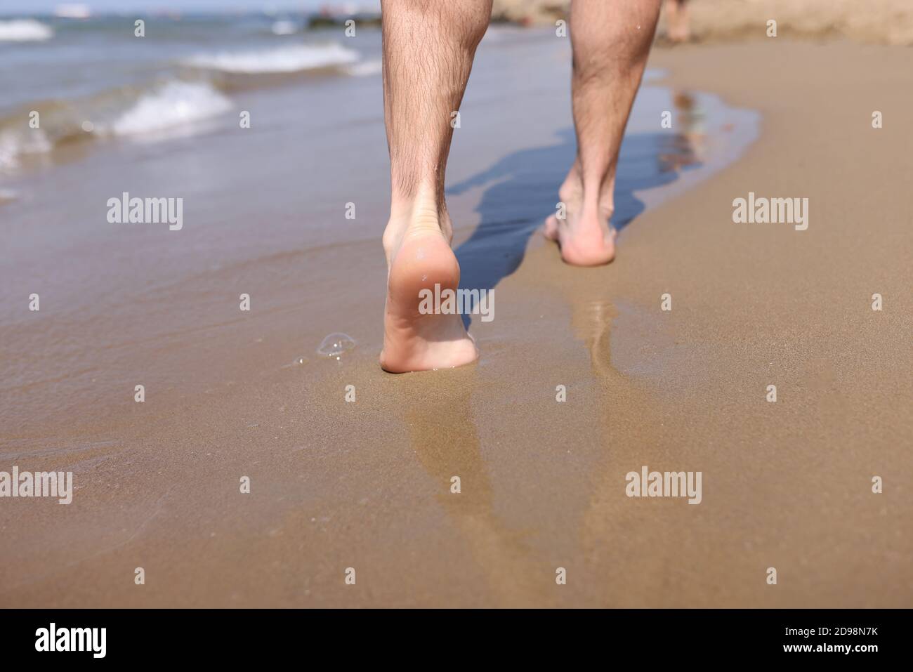 Male feet walking on sand hi-res stock photography and images - Alamy