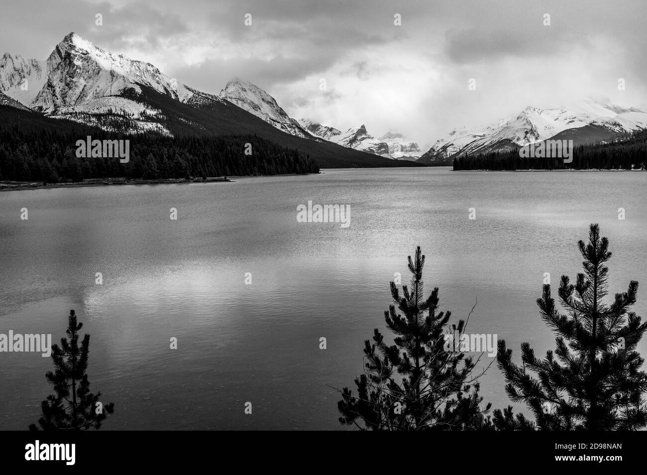 black and white image of Maligne Lake in early winter in Jasper National Park, Canada Stock Photo