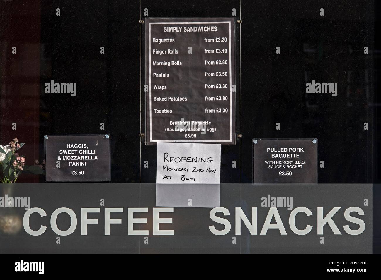 Notice in the window of a Cafe in Edinburgh reopening after lockdown during the covid-19 pandemic. Stock Photo
