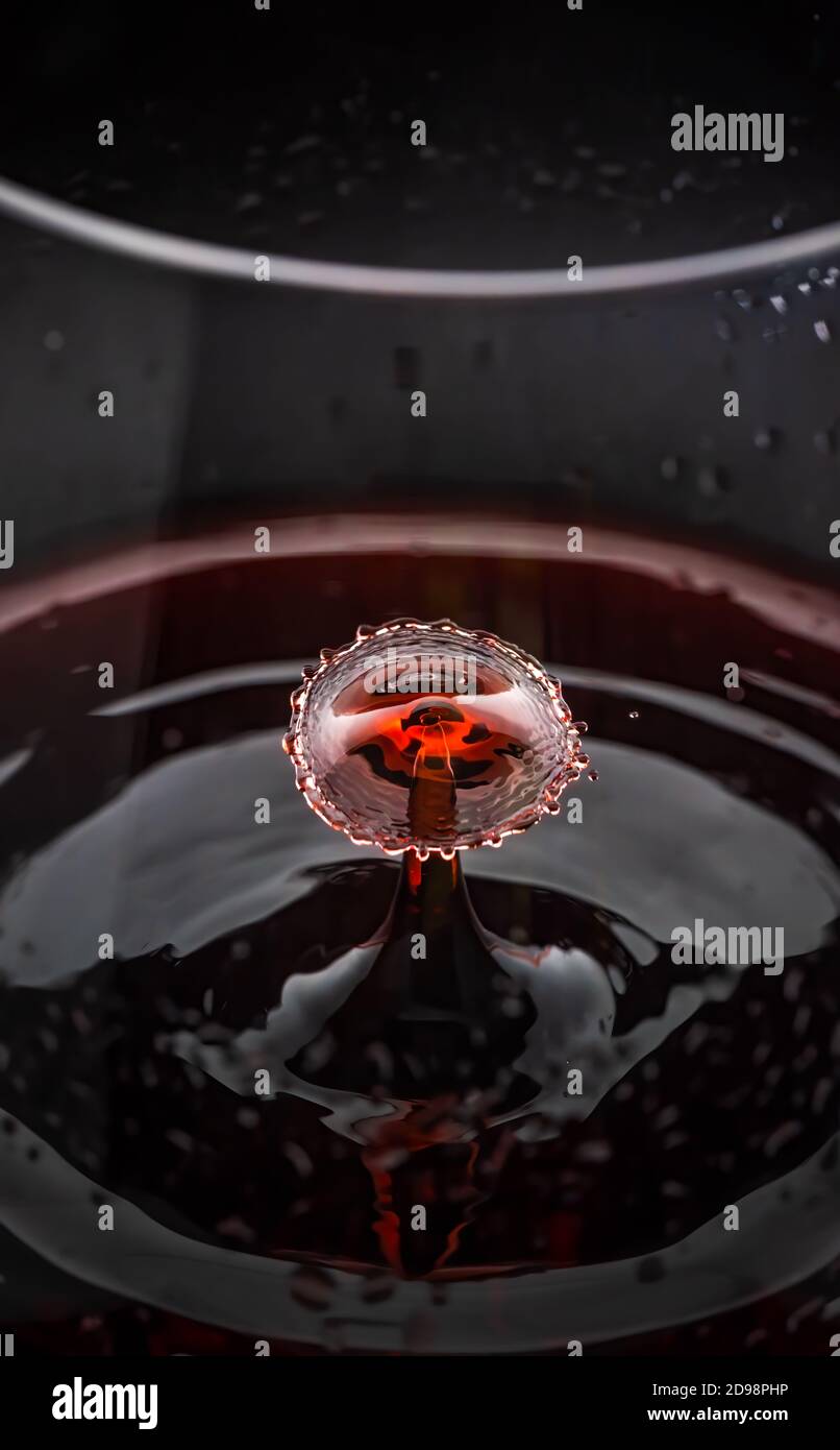 Red wine drop splashing inside glass close up Stock Photo Alamy