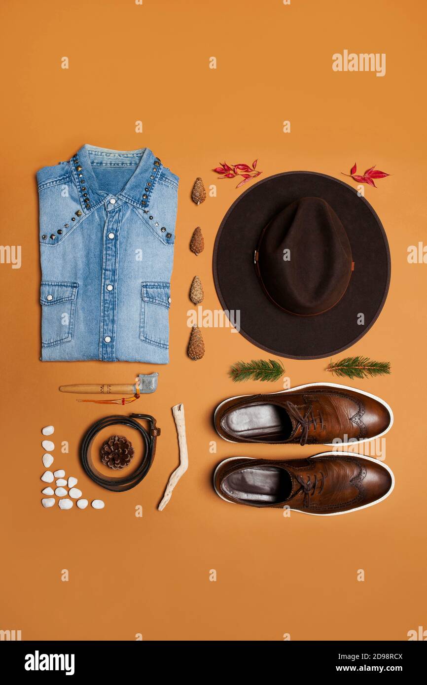 Masculine western outfit still life on a brown background with boots and cowboy hat Stock Photo