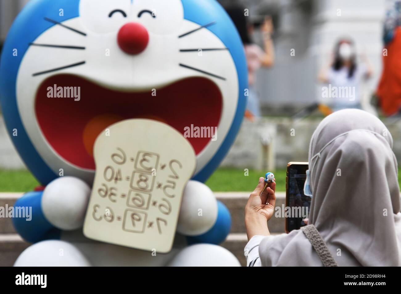 Singapore 27th Dec A Visitor Takes Photos Of Her Own Doraemon Figurine With One Of The Exhibited Doraemon Figure At The Doraemon S Time Travelling Adventures In Singapore Exhibition Held At The National
