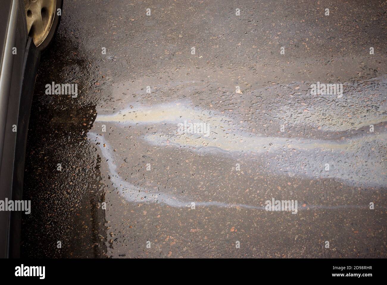 Oil stain caused by a leak under an old car Stock Photo Alamy