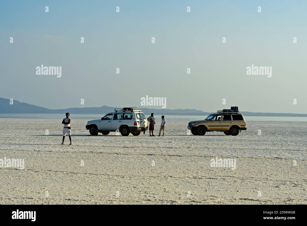 Two off-road vehicles of a tour group parking more than 100 meters below sea level on the Assale Salt Lake, Danakil Depression,Afar Triangle, Ethiopia Stock Photo