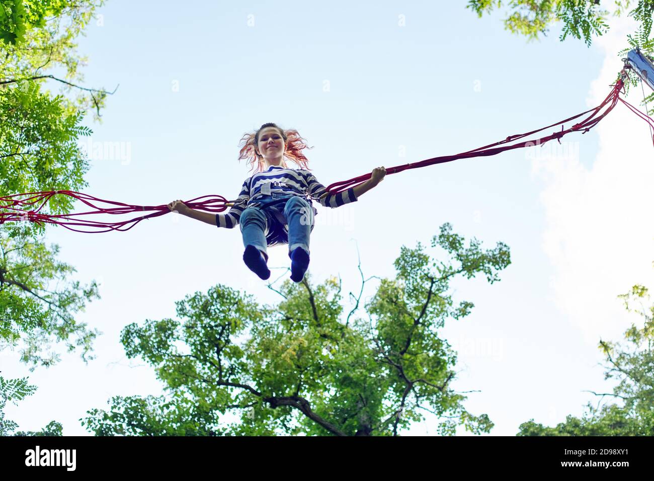 Teenage girl jumping on trampoline hires stock photography and images