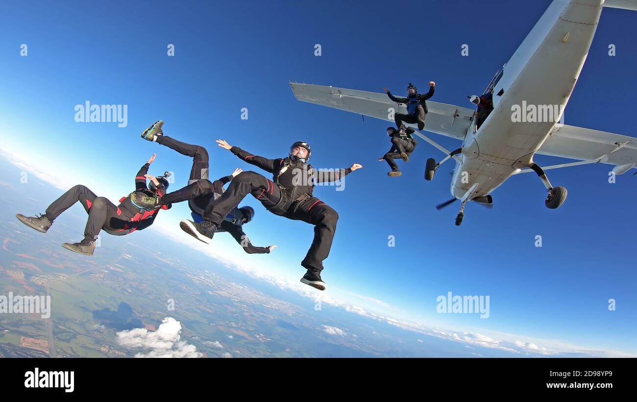 Skydivers having fun jumping out the plane Stock Photo Alamy
