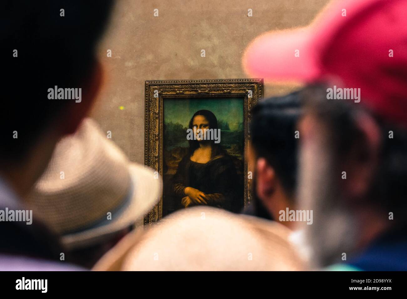 The famous painting by Leonardo da Vinci Mona Lisa in the Louvre Museum in Paris, France. Delighted tourists look at the piece of art, you can not see Stock Photo