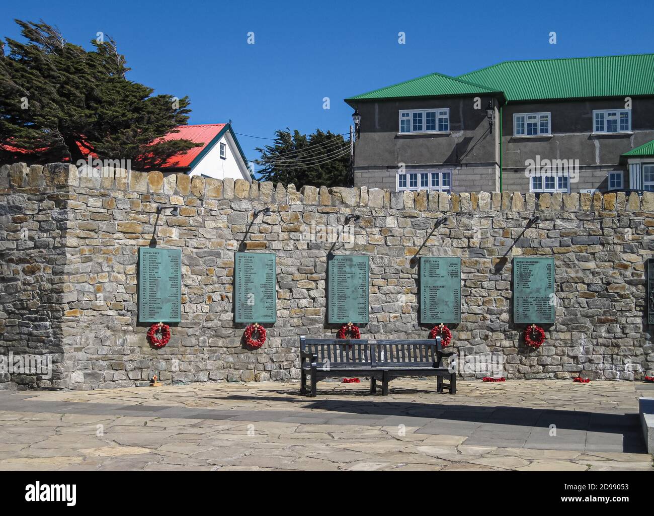 Stanley, Falkland Islands, UK - December 15, 2008: Against gray stone wall, green metal plates with names of fallen soldiers and sailors at Liberation Stock Photo