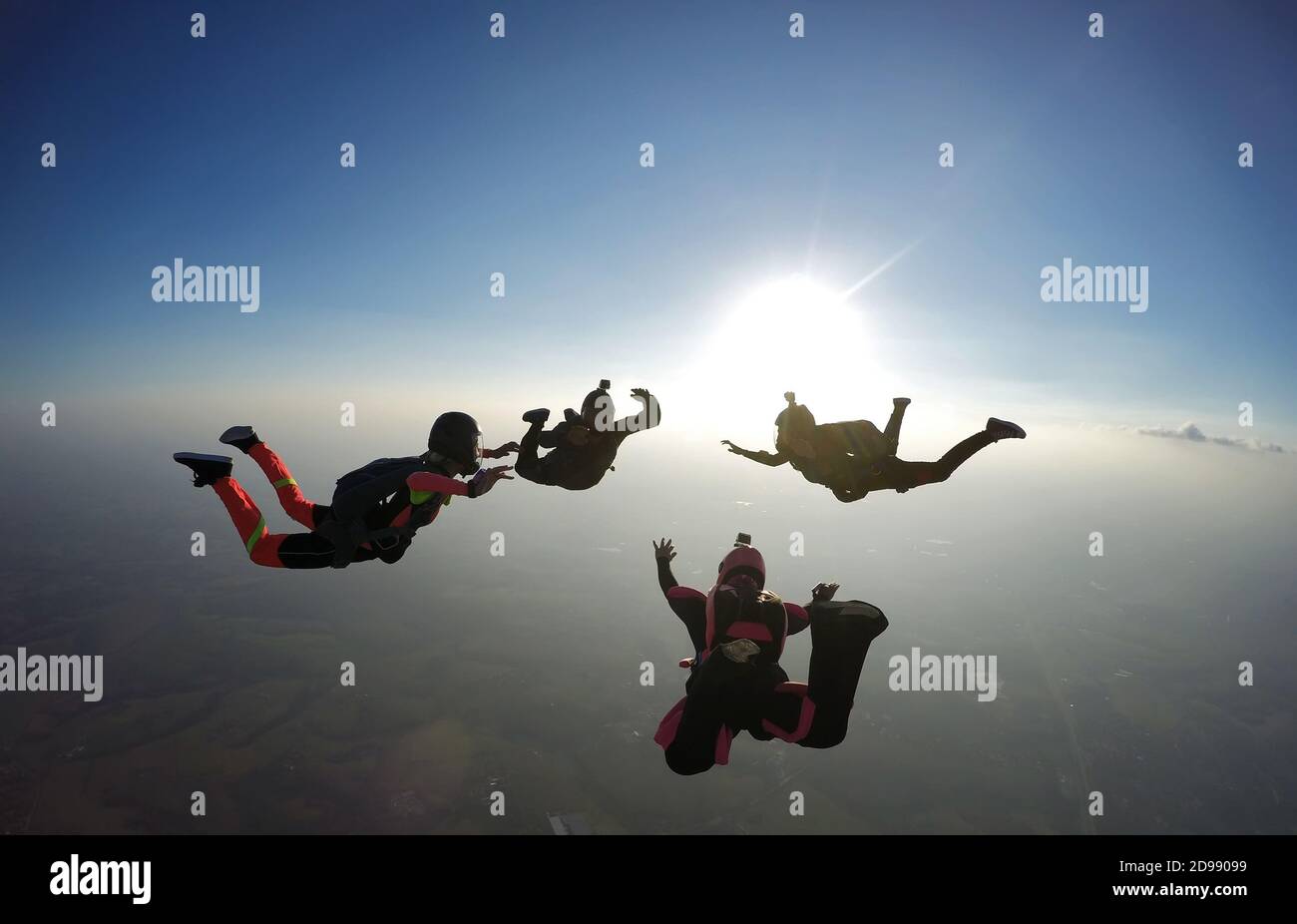 Skydivers having fun at the sunset Stock Photo
