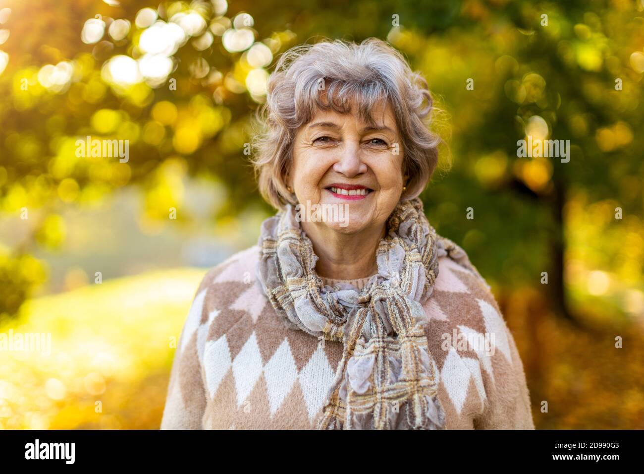Portrait of a happy senior woman outdoors in autumn Stock Photo