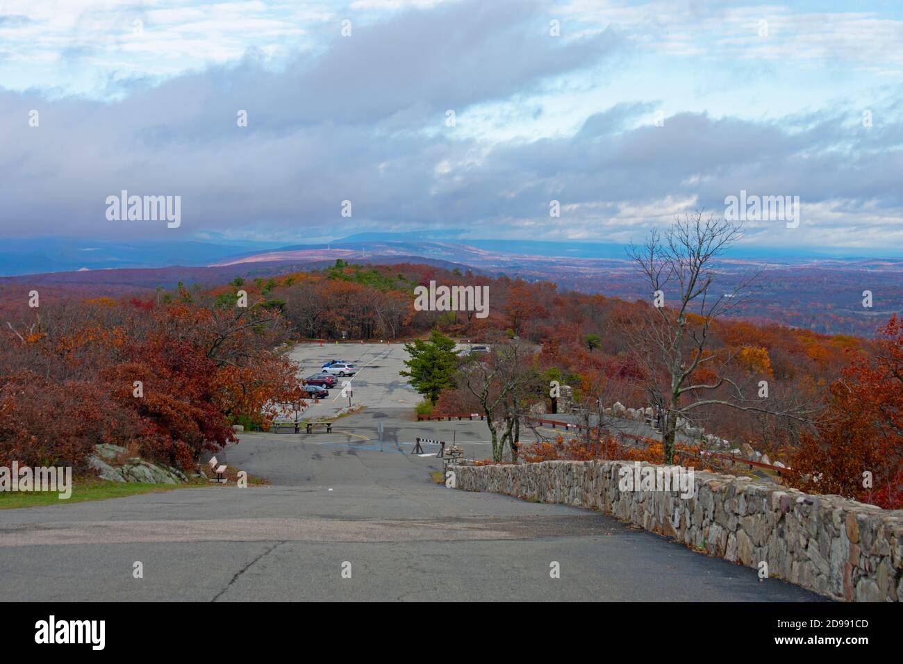 Cloudy skies, an automobile parking area, and lush Autumn foliage at High Point Monument area of High Point State Park in New Jersey, USA -06 Stock Photo