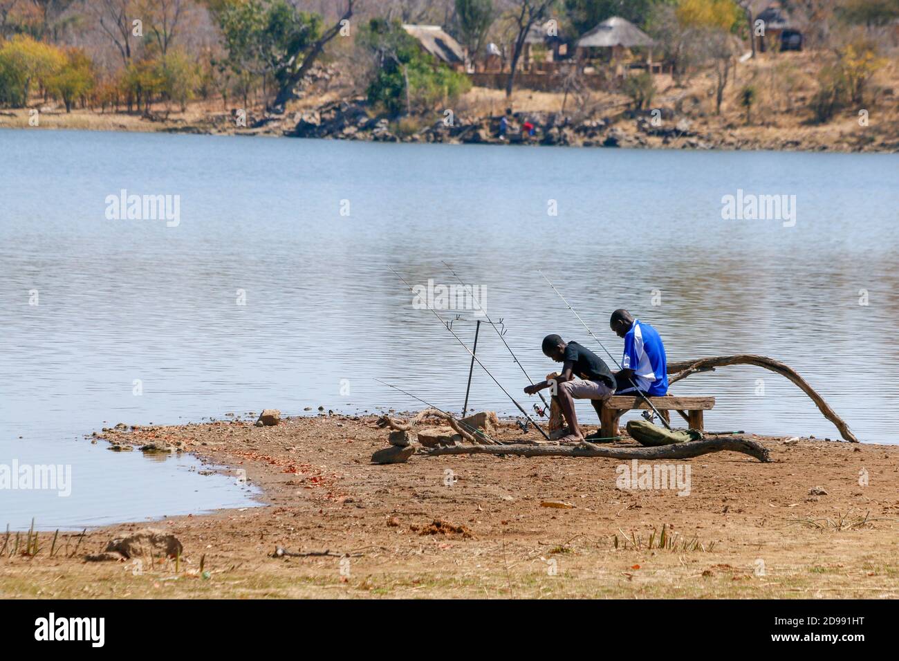 People fishing with fishing rods at a lake. Zimbabwe. Stock Photo