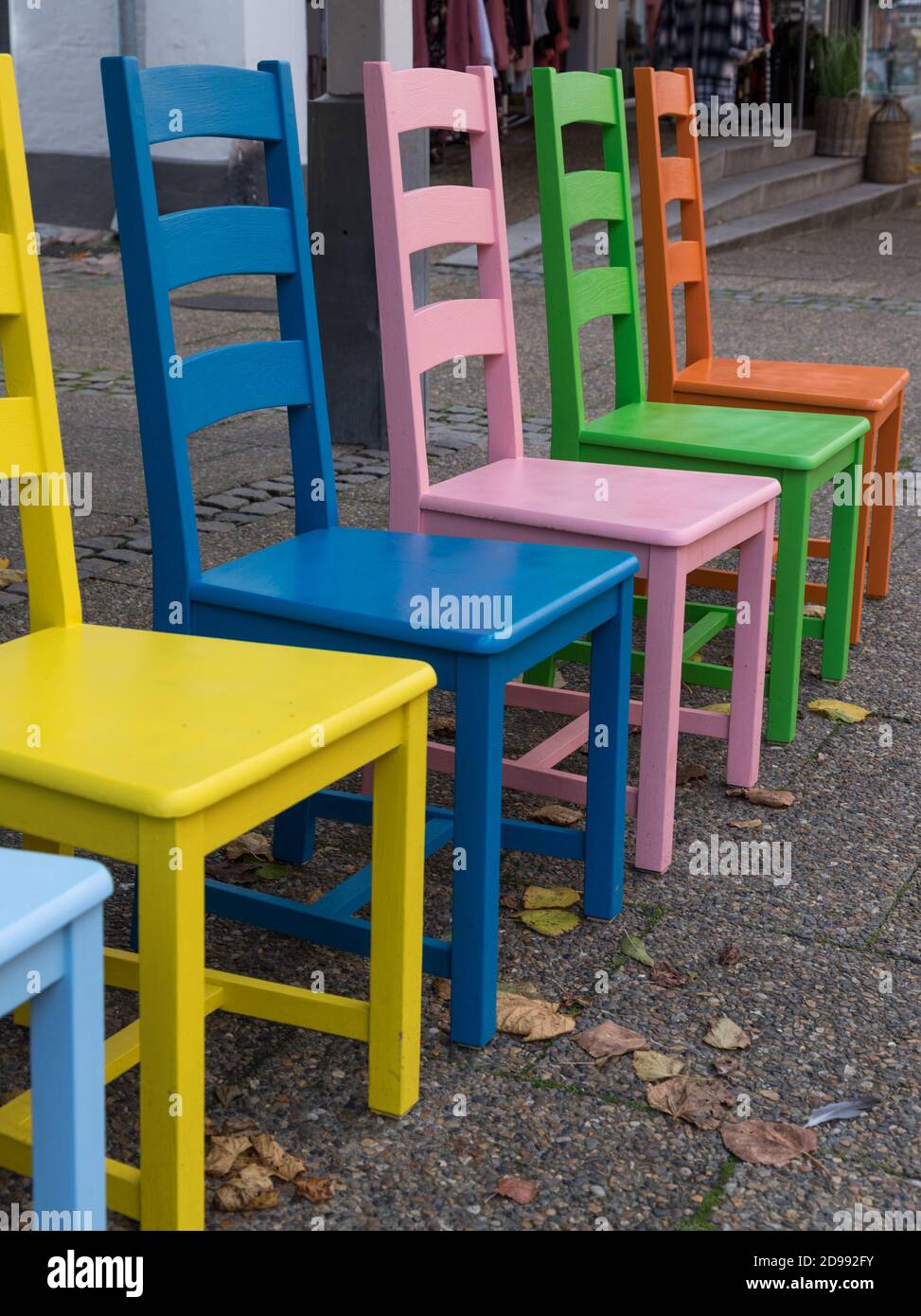 close-up of colored wooden chairs in a row Stock Photo