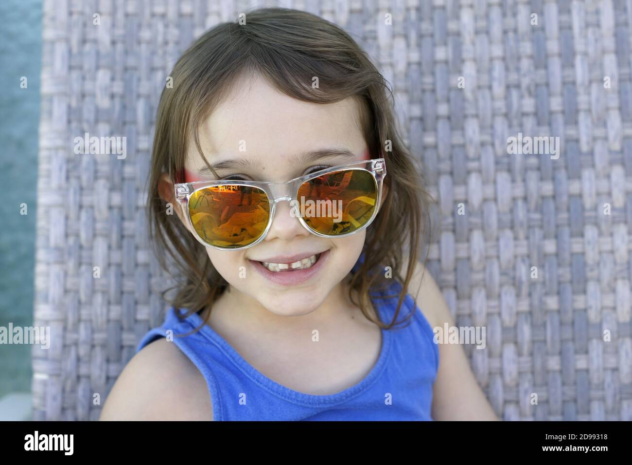 Beautiful little girl wearing sunglasses with defocused background Stock Photo