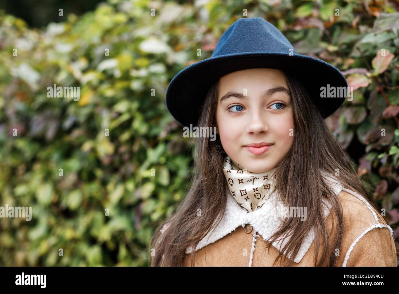 Young teenage girl in a black hat stands on the street Stock Photo - Alamy
