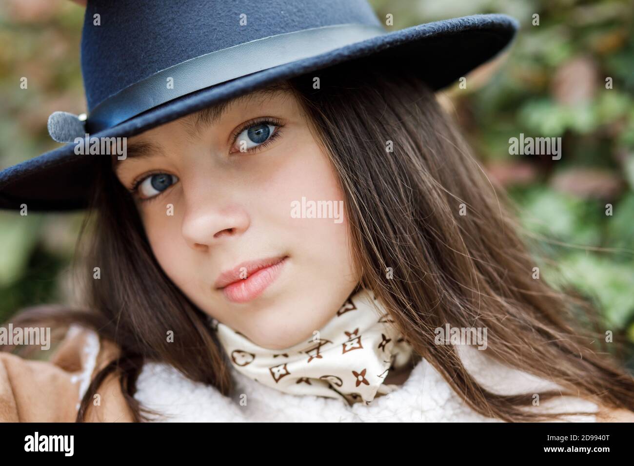 Young teenage girl in a black hat stands on the street Stock Photo - Alamy