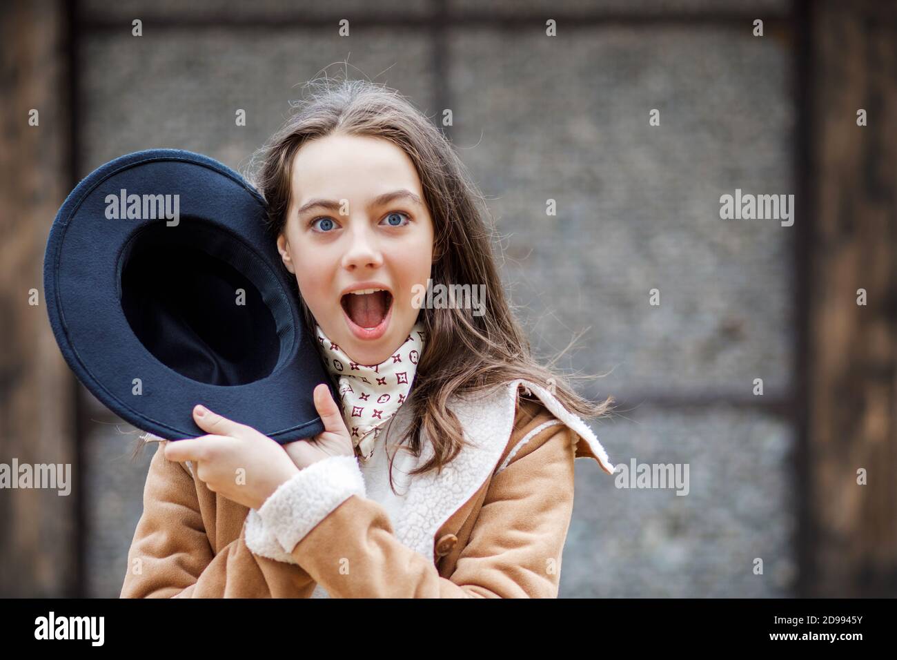 Young pretty teenage girl in a black hat stands on the street Stock ...