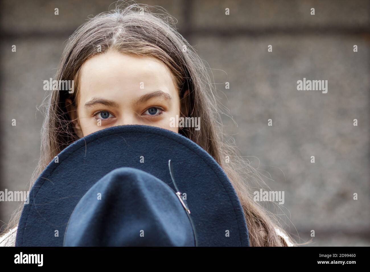 Young pretty teenage girl in a black hat stands on the street Stock ...