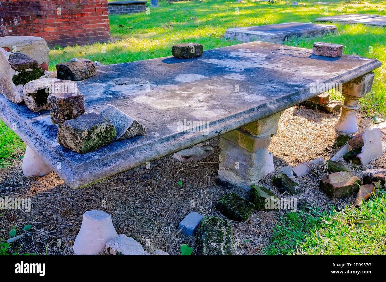 An aboveground grave is elevated with bricks in Church Street