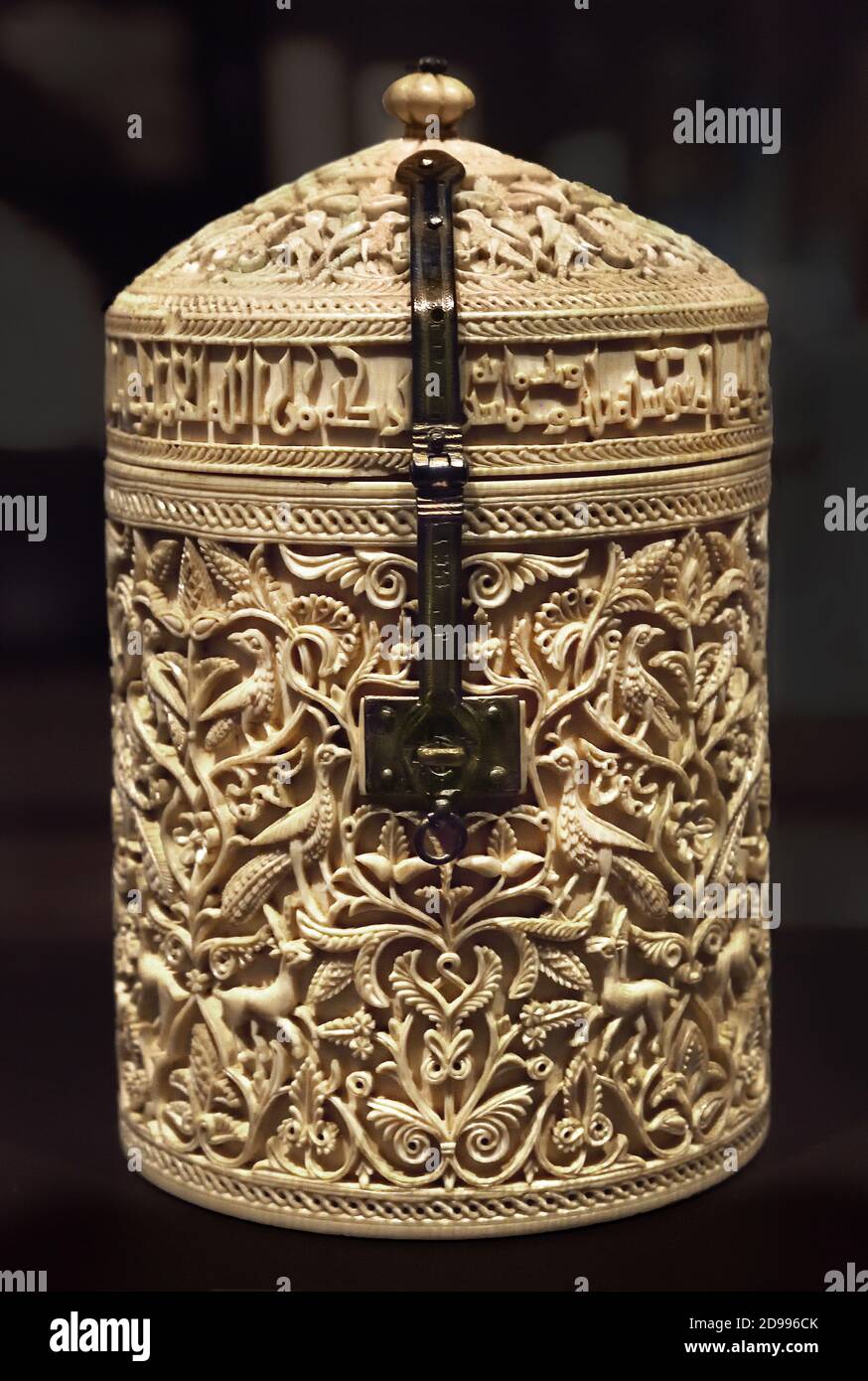 Zamora, pyxis ,Córdoba 353 ,after Hijra / 964 AD , National Archaeological Museum of Spain in Madrid, Spain. ,Ivory box,shape of a cylindrical tusk , dome-shaped lid, that opens and closes with a hinge and a silver clasp, with niello detailing, The delicate carving creates chiaroscuro ,effects with the decorative motifs, arabesques and palmettes, gazelles, peacocks and other birds that recreate a palace garden ) Stock Photo