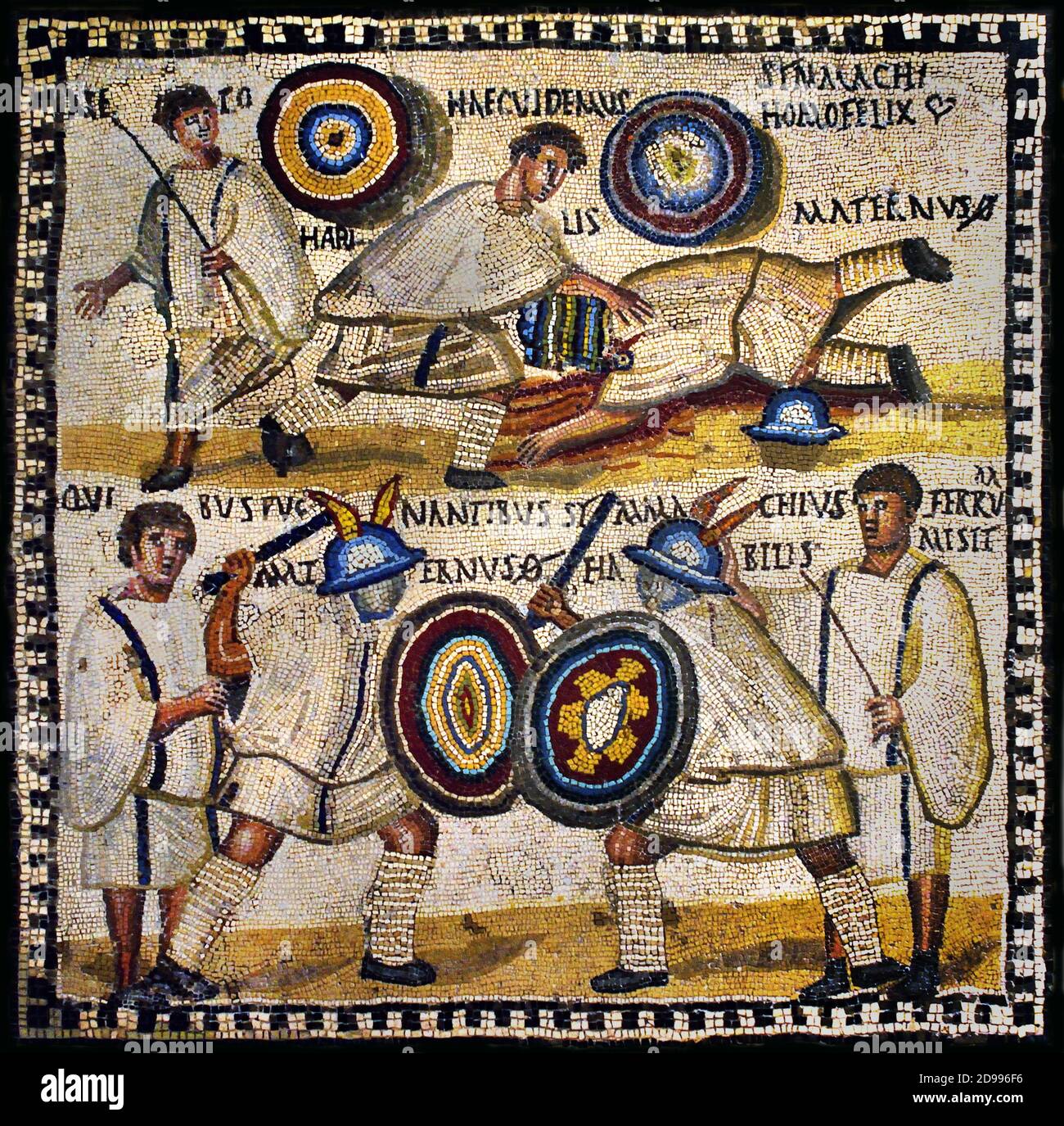 Gladiator fight depicted in the Roman mosaic from the 3rd century AD   According to the Latin inscription, the murmillo (Roman armed gladiator) Symmachus is fighting versus the murmillo Maternus, cheered on by the lanistae (gladiator trainers) National Archaeological Museum Spain. Stock Photo