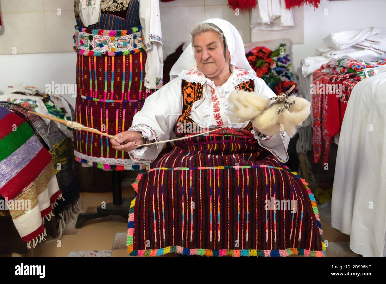 An old woman weaver spun wool on her hand. An old extinct craft Stock Photo  - Alamy