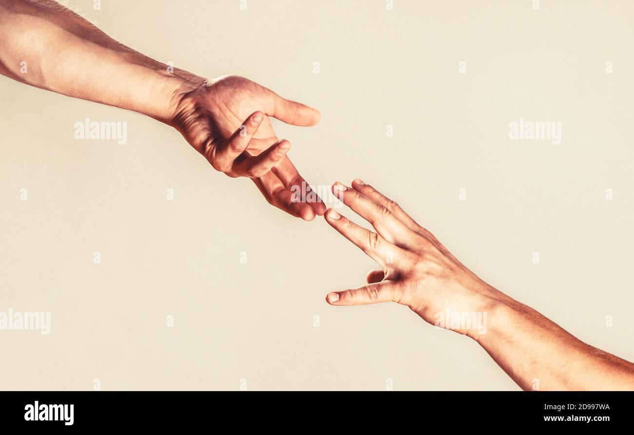 Two hands, helping arm of a friend, teamwork. Helping hand outstretched, isolated arm, salvation. Close up help hand Stock Photo