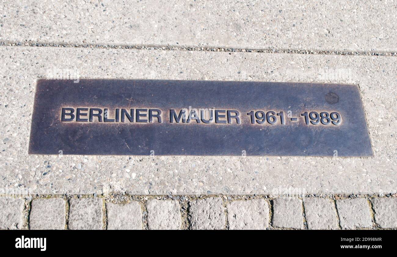 Commemorative plaque at the site where the Berlin Wall once divided the city Stock Photo