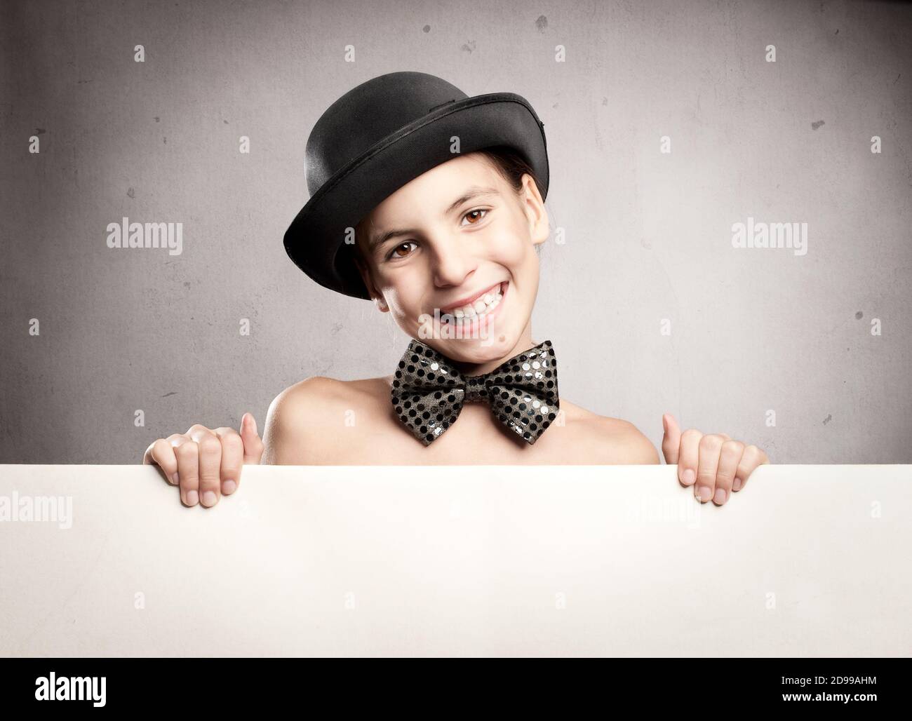 happy little girl wearing a bowler hat and holding a banner Stock Photo ...