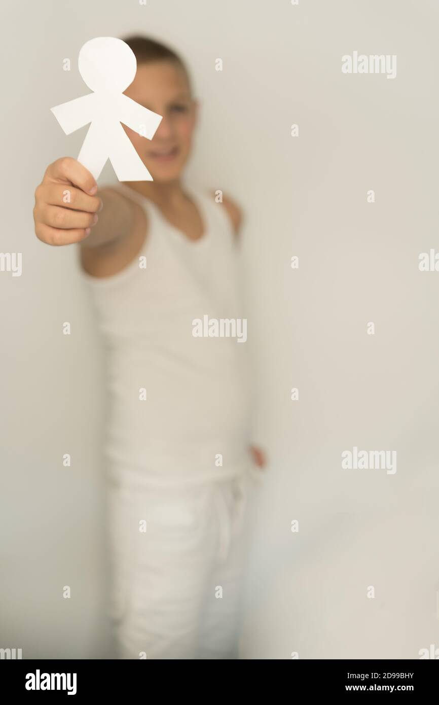 Human Using Paper Vertical shot of a boy holding a paper human Stock Photo - Alamy