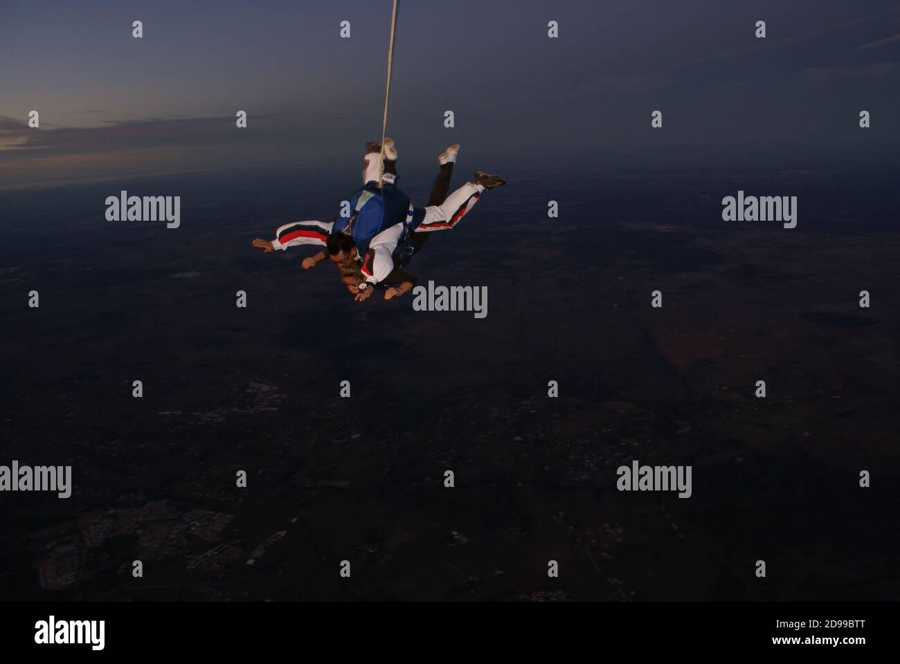 A woman tourist jumps on a parachute at dusk in Évora Portugal - October 24, 2009 Stock Photo