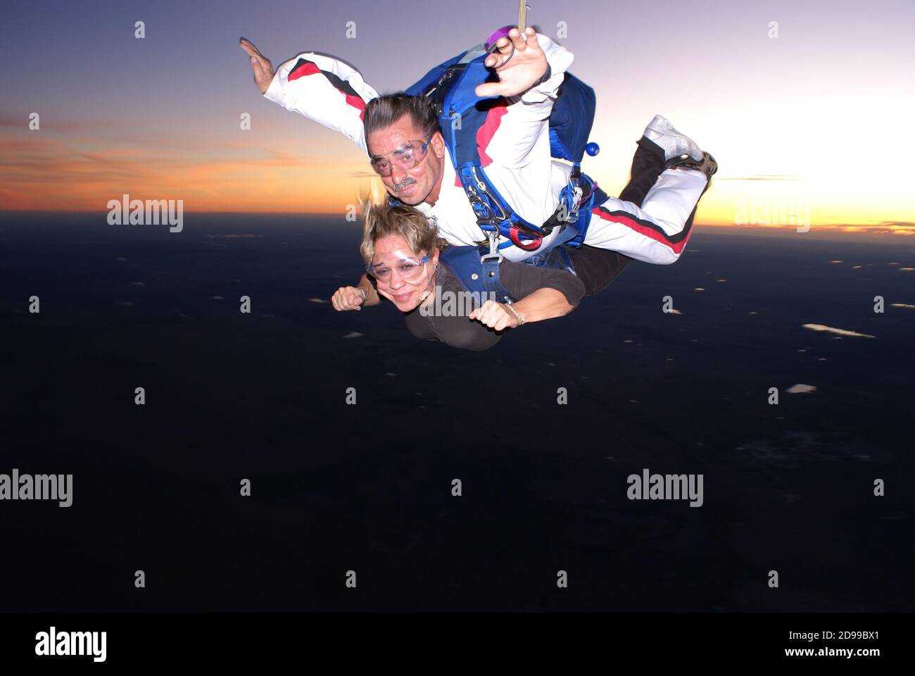 A woman tourist jumps on a parachute at dusk in Évora Portugal - October 24, 2009 Stock Photo