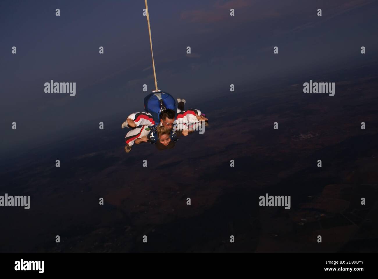 A woman tourist jumps on a parachute at dusk in Évora Portugal - October 24, 2009 Stock Photo
