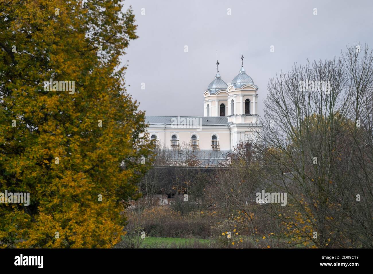 Newly painted Church of St. Archangel Michael in Lyduokiai near Ukmerge in Lithuania on a late autumn day with trees around Stock Photo