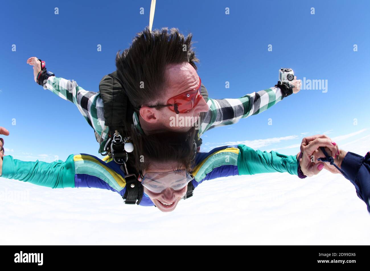 Sky diving tandem holding hands Stock Photo