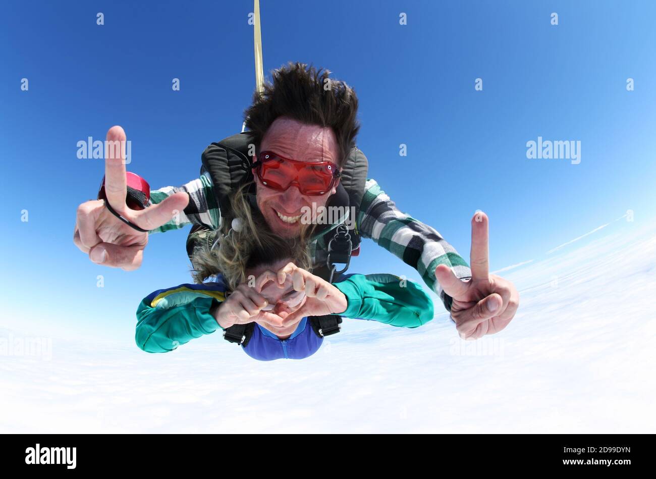 Sky diving tandem holding hands Stock Photo
