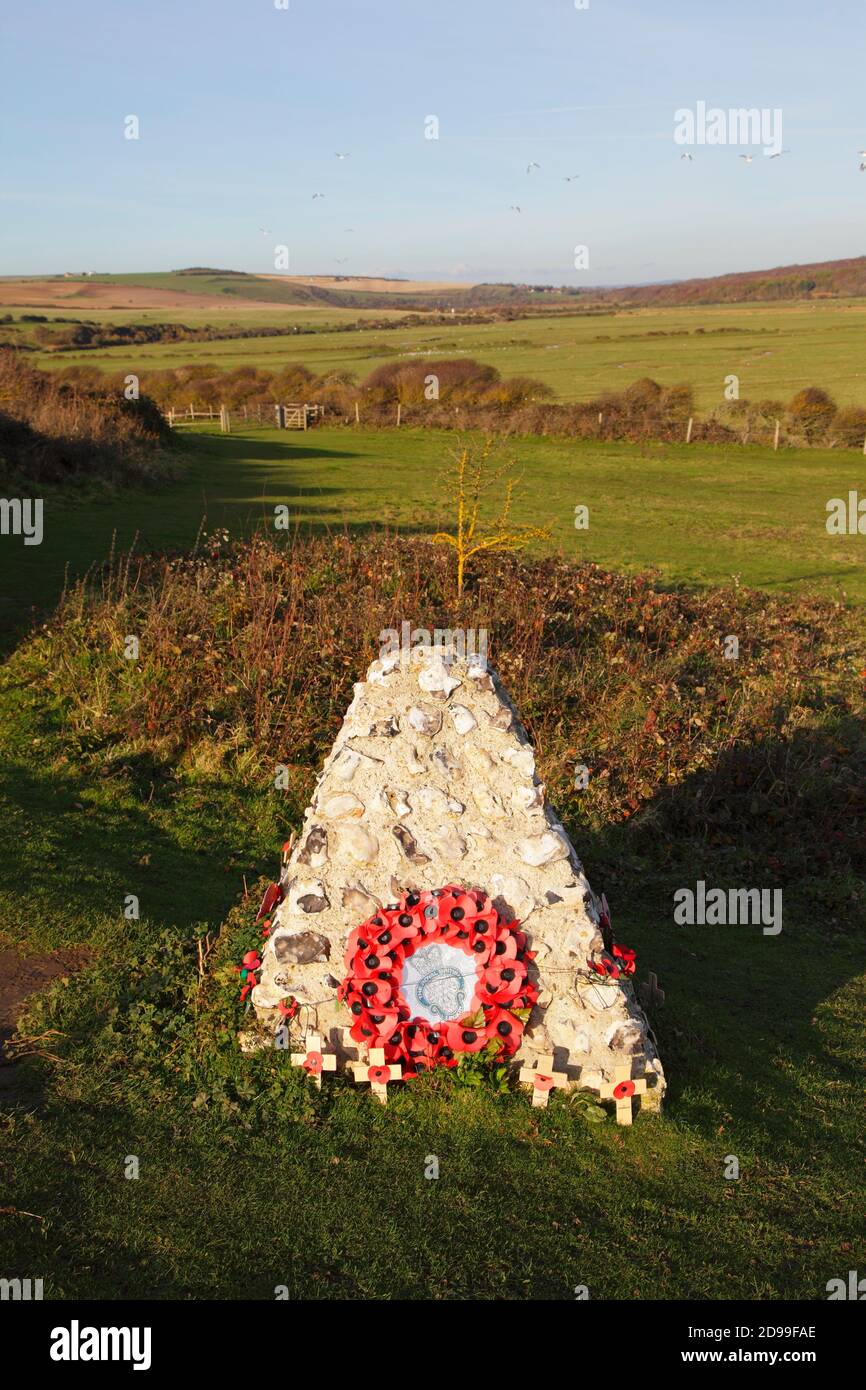 British Legion Memorial poppy wreath on a stone cairn, Seaford Head, East Sussex, UK Stock Photo