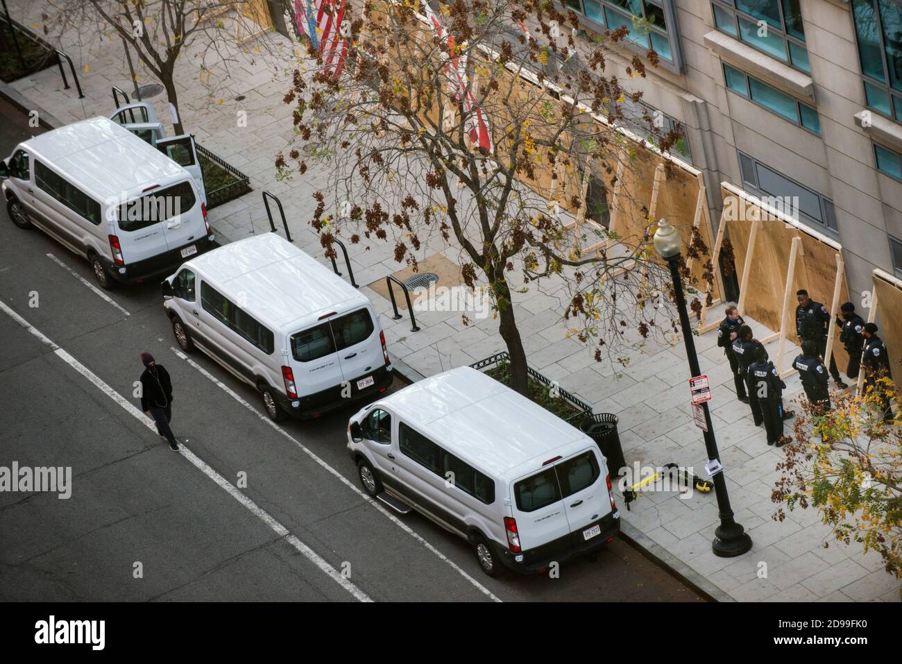 Washington DC, USA. 3rd Nov 2020. Metropolitan DC Police standing by in front of boarded up storefronts in front of their vans along E St NW on Election day 3rd November 2020, in anticipation of election related riots. Yuriy Zahvoyskyy / Alamy Live News. Stock Photo