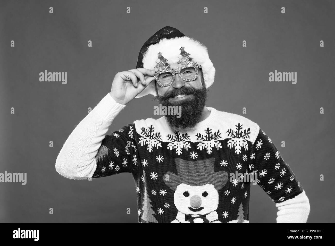 Every Santa needs a pair of these accessories. Happy santa wear fancy glasses. Bearded man with xmas tree party accessories. Festive costume accessories. Holiday accessories. Christmas and new year. Stock Photo