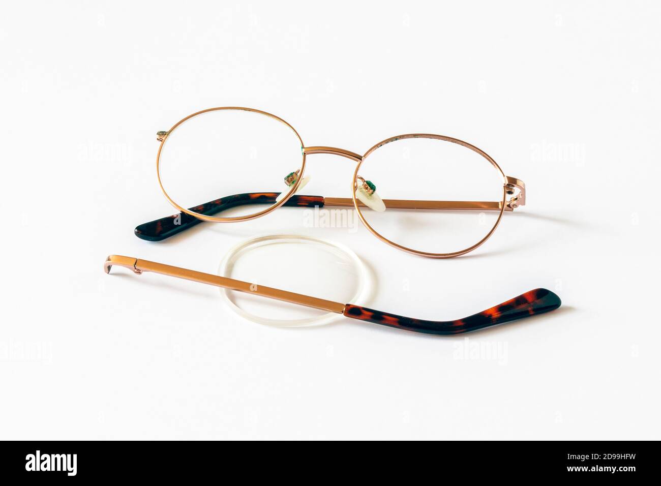 A broken pair of glasses on a white background Stock Photo