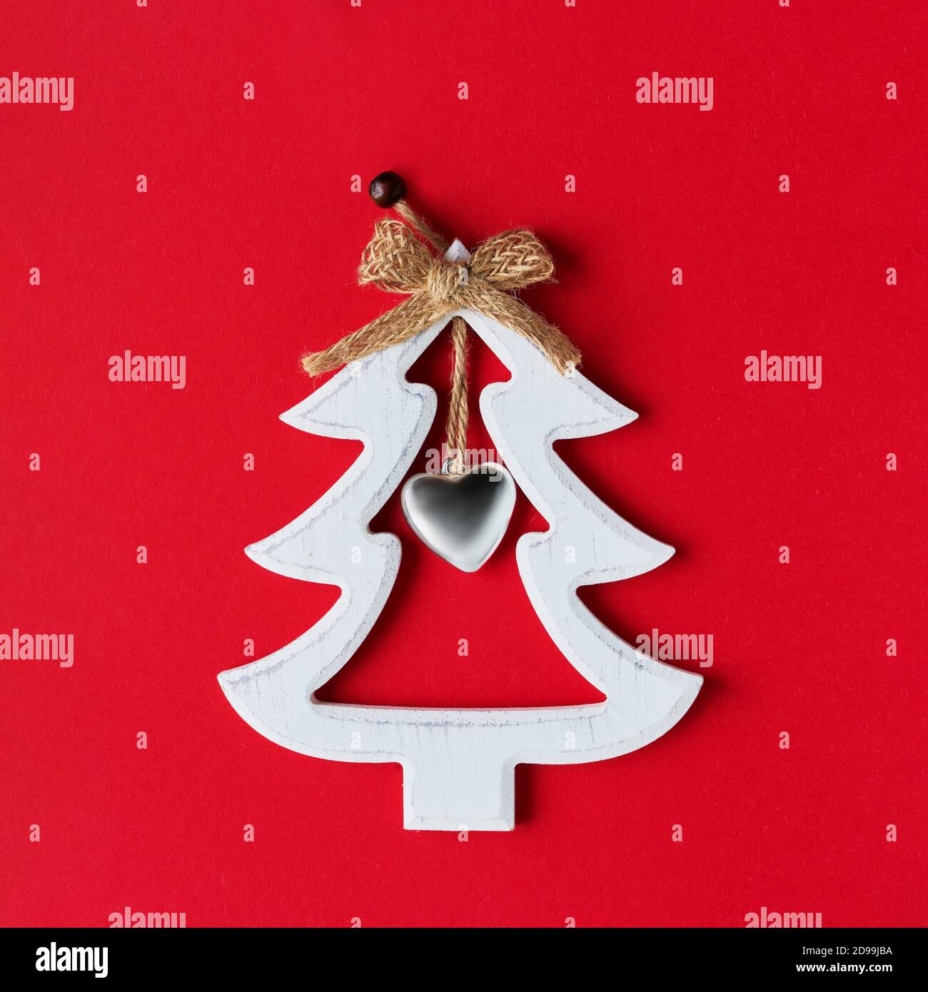 White wooden Christmas tree on a bright red background. Top view, copy space Stock Photo
