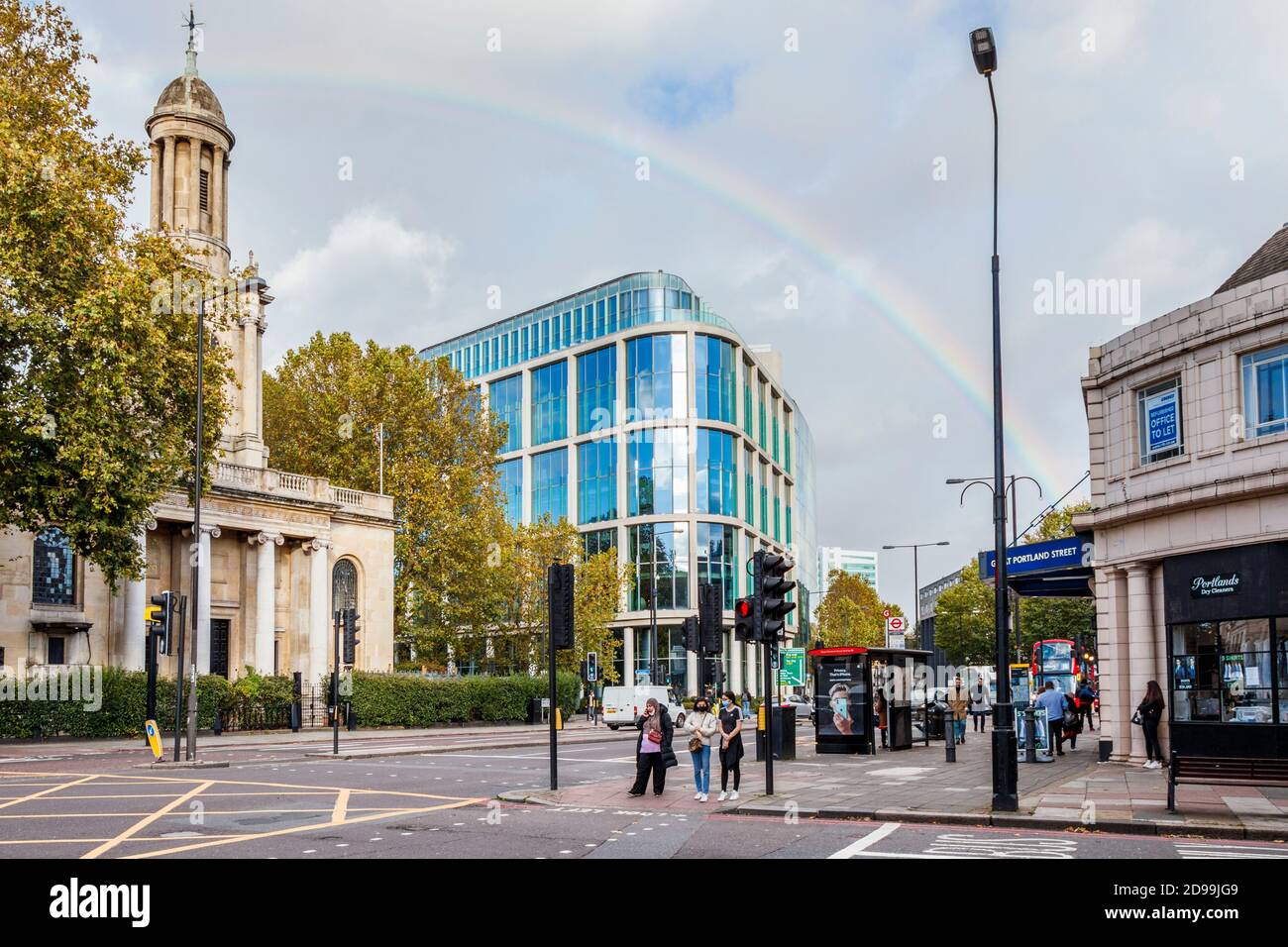 A rainbow arcs above Great Portland Street Tube and Commonwealth Church on Marylebone Road on a sunny October afternoon, London, UK Stock Photo