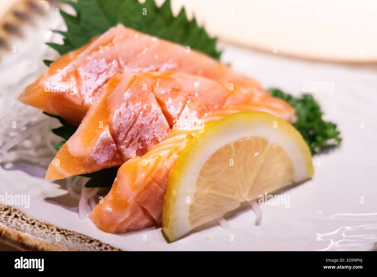 Fresh salmon belly sashimi served on plated in Japanese restaurant